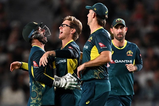 Australia's Adam Zampa celebrates with team-mates during the second T20 international against New Zealand at Eden Park in Auckland on 23 February 2024. (Photo by Hannah Peters/Getty Images)