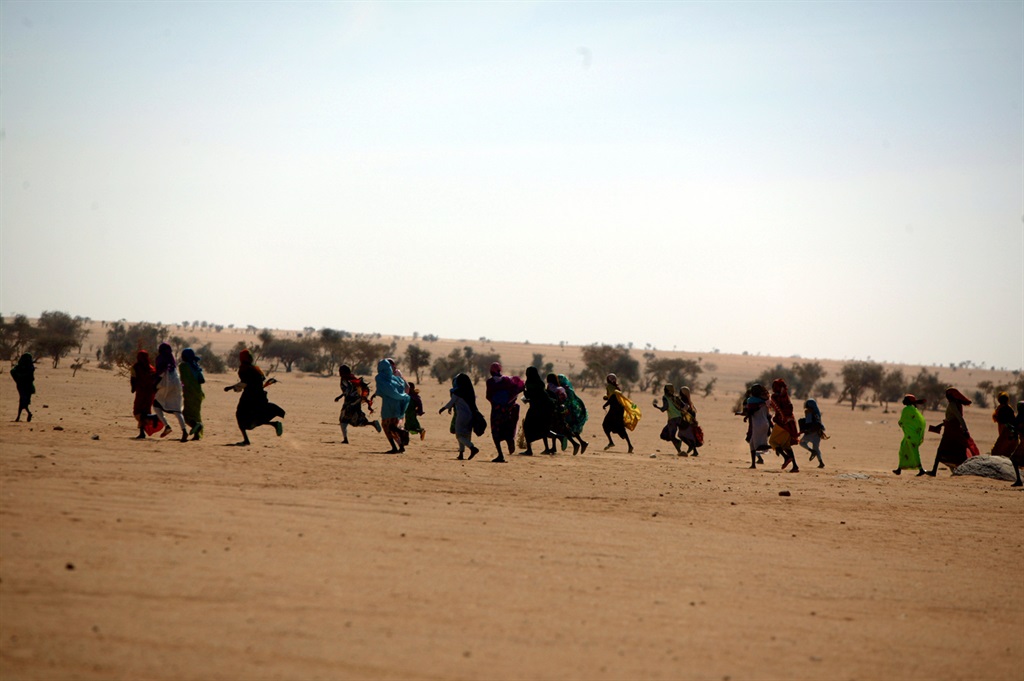 FILE: Inhabitants of the Oure Cassoni Refugee Camp in Chad run to the site of a reported killing, in December 2006. The camp housed those who had fled the Janjaweed, precursor to the RSF. (Photo by Robert Sabo/NY Daily News Archive via Getty Images)