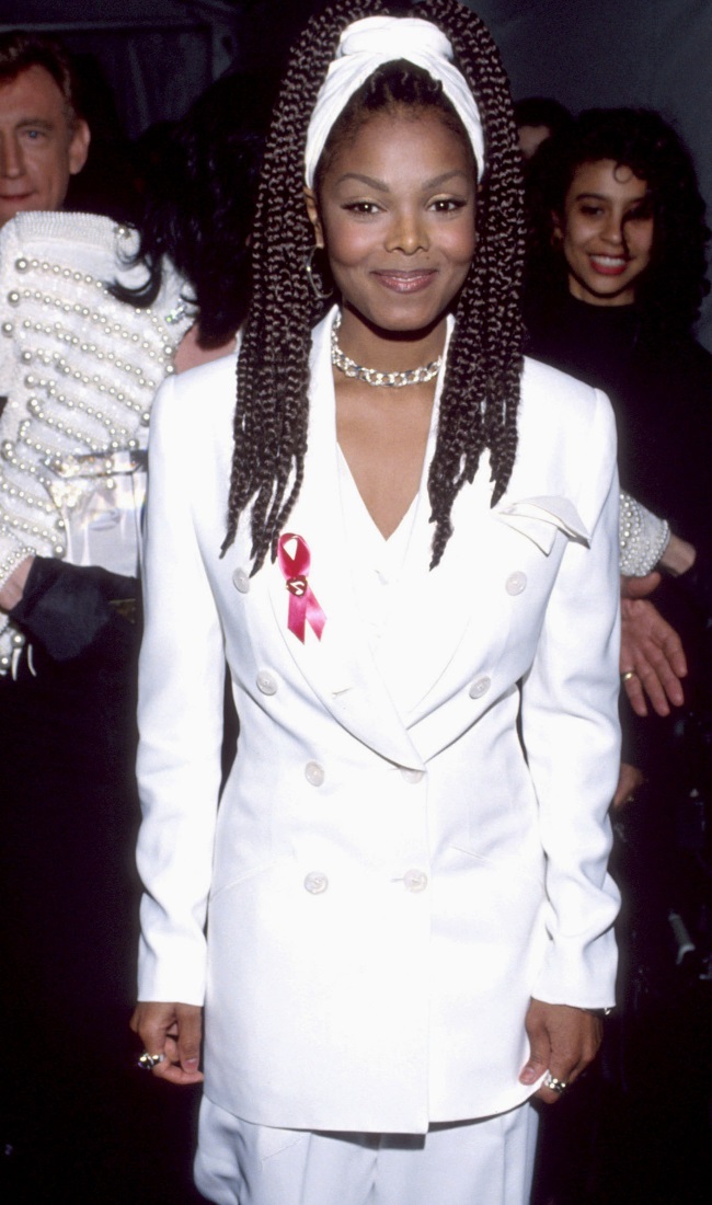 Janet Jackson donned a chic white suit and red ribbon to raise awareness for AIDS in 1993. (CREDIT: Gallo Images / Getty Images)