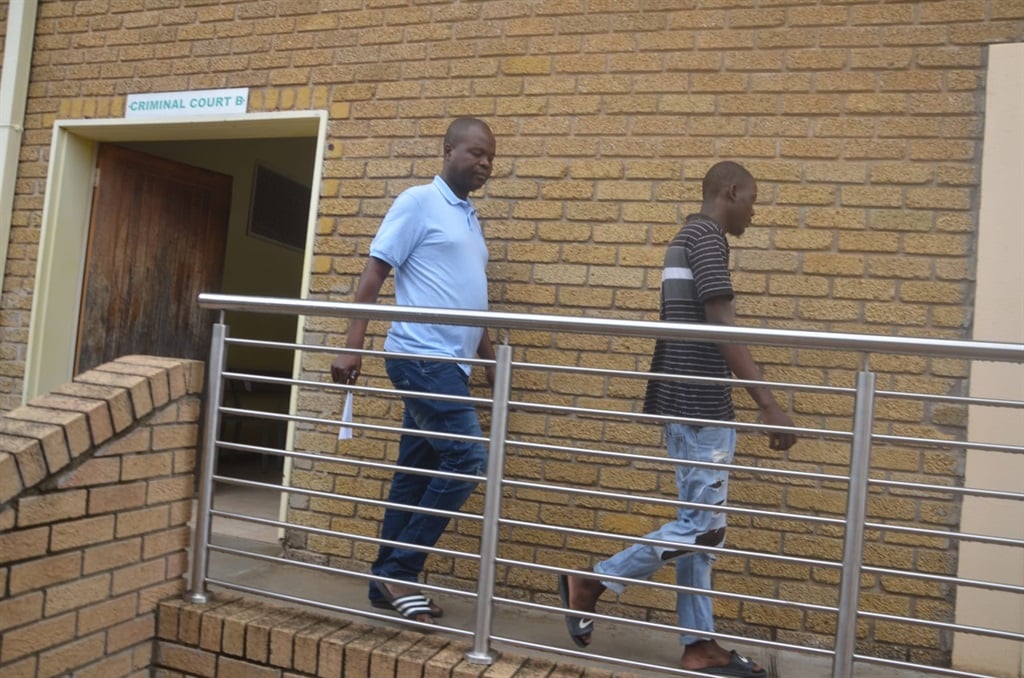 Bright Mncube is being escorted by police  to jail from the Mhala Regional court to serve his 15 years sentence. Photo by Oris Mnisi 