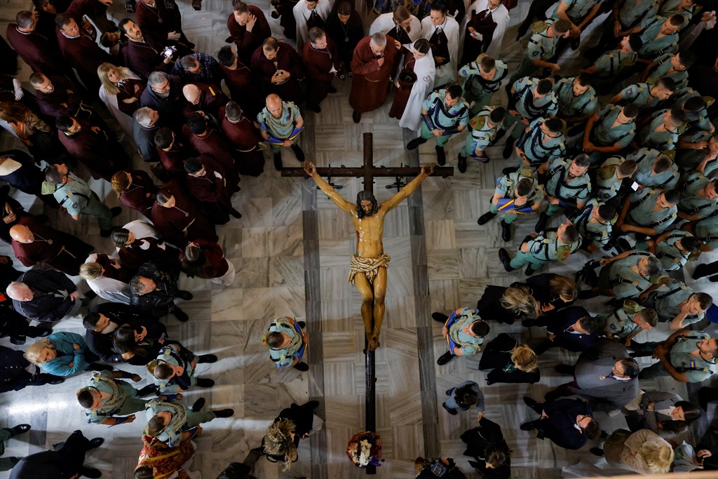 Spanish legionnaires and penitents stand next to a statue of Christ, known as the Christ of the Good Death, inside a church after the governing body of the Ecce-Homo brotherhood decided that penance could not be carried out in the streets due to the heavy rain of the Nelson storm during the Holy Week, in Ronda, Spain, 28 March 2024 