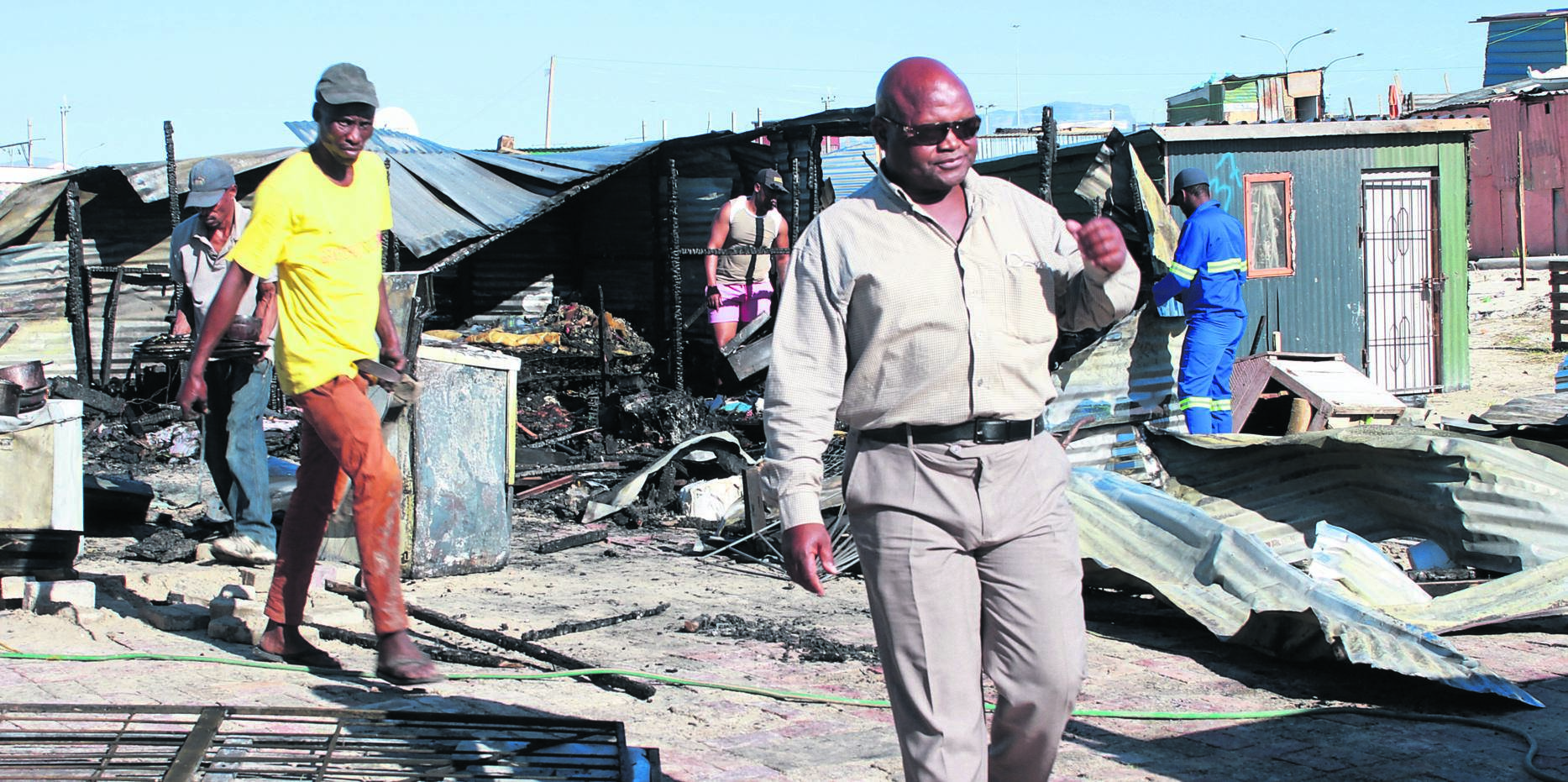 Residents Nceba Nkomane and Mzwandile Rasmeni lost all their belongings in the fire on Wednesday night. Photo by Lindile Mbontsi