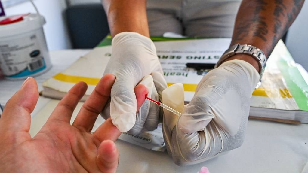 Blood is being drawn for the HIV test kit at King 