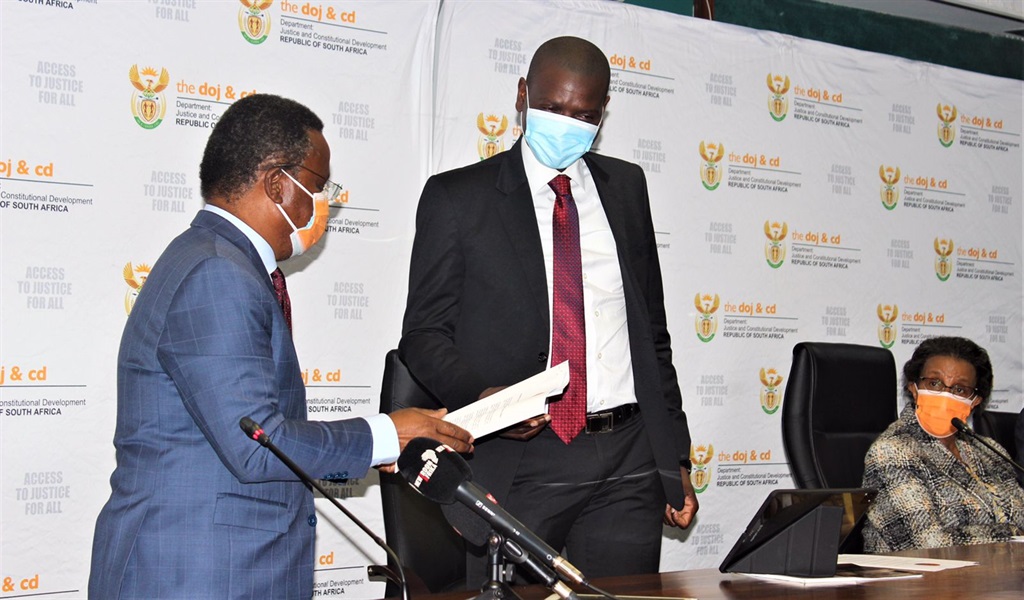 Justice Minister Ronald Lamola receives a memorandum from Reverend Frank Chikane, from Defend our Democracy campaign. Picture: Ministry of Justice. 