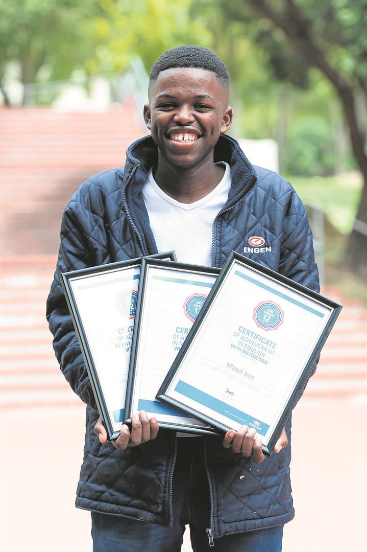 Inga Mhlauli(18) carrying his certificates.