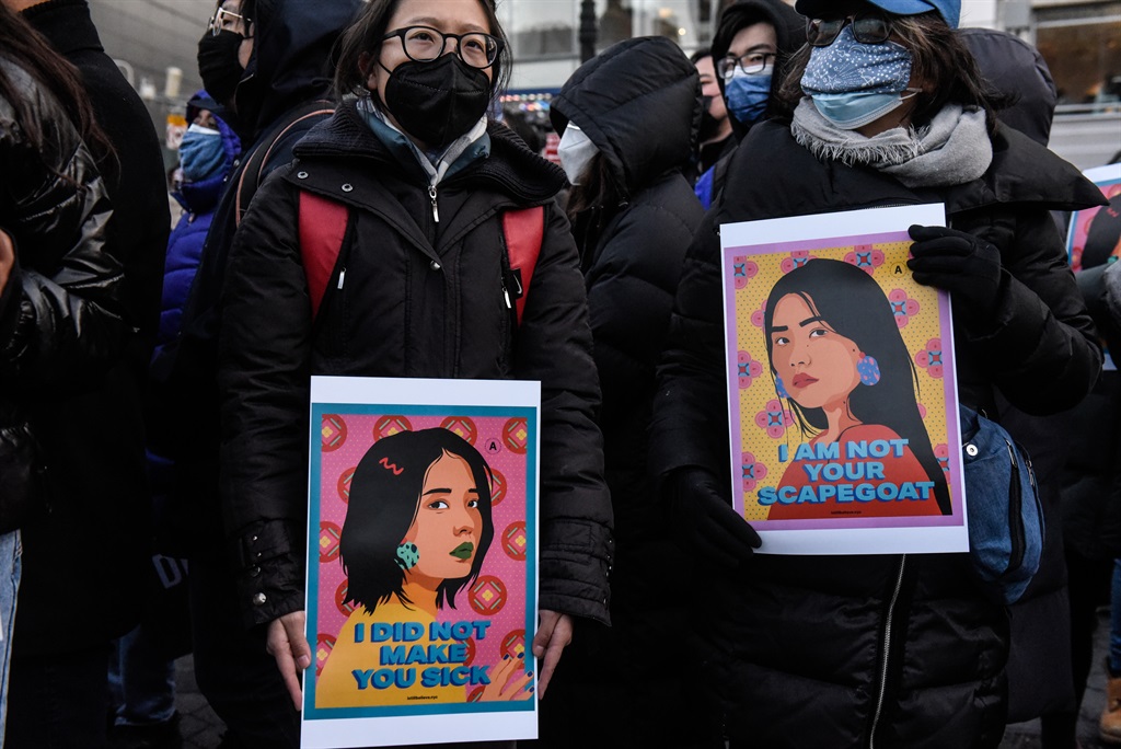 People participate in a peace vigil to honour victims of attacks on Asians on 19 March 2021 in Union Square Park in New York City. (Photo by Stephanie Keith/Getty Images)