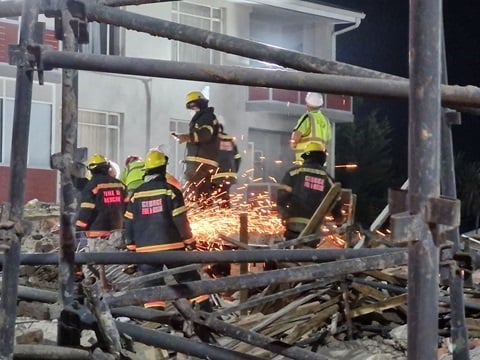 Emergency personnel at the site where a building collapsed leaving 75 construction workers trapped in the rubble. (Supplied/Garden Route District Municipality)