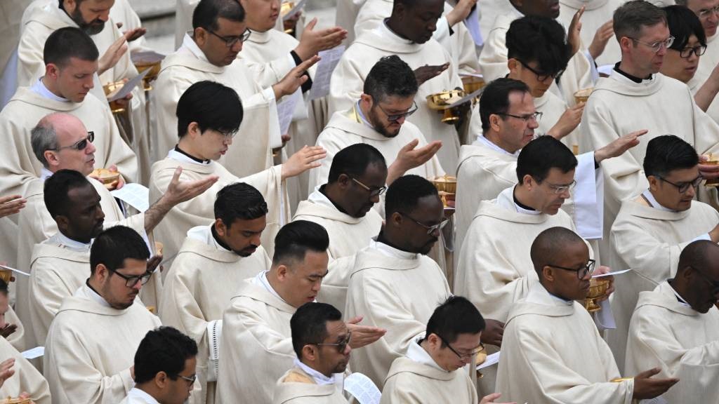 Priests attend the Easter Mass as part of the Holy