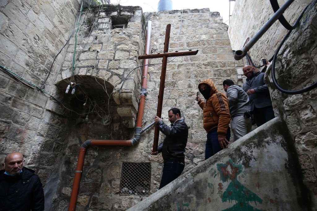 Christians walk along Via Dolorosa on quiet Good Friday due to the restrictions on public gatherings amid the coronavirus (Covid-19) in Jerusalem on April 10, 2020.