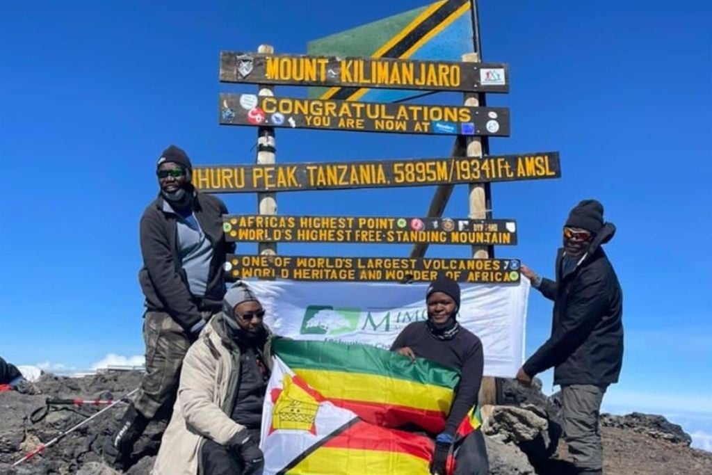 From left to right: Bekithemba Nyathi, George Nyambiya, Faith Maipisi, and Blessing Garamumhango at the top of Kilimanjaro. (Supplied)
