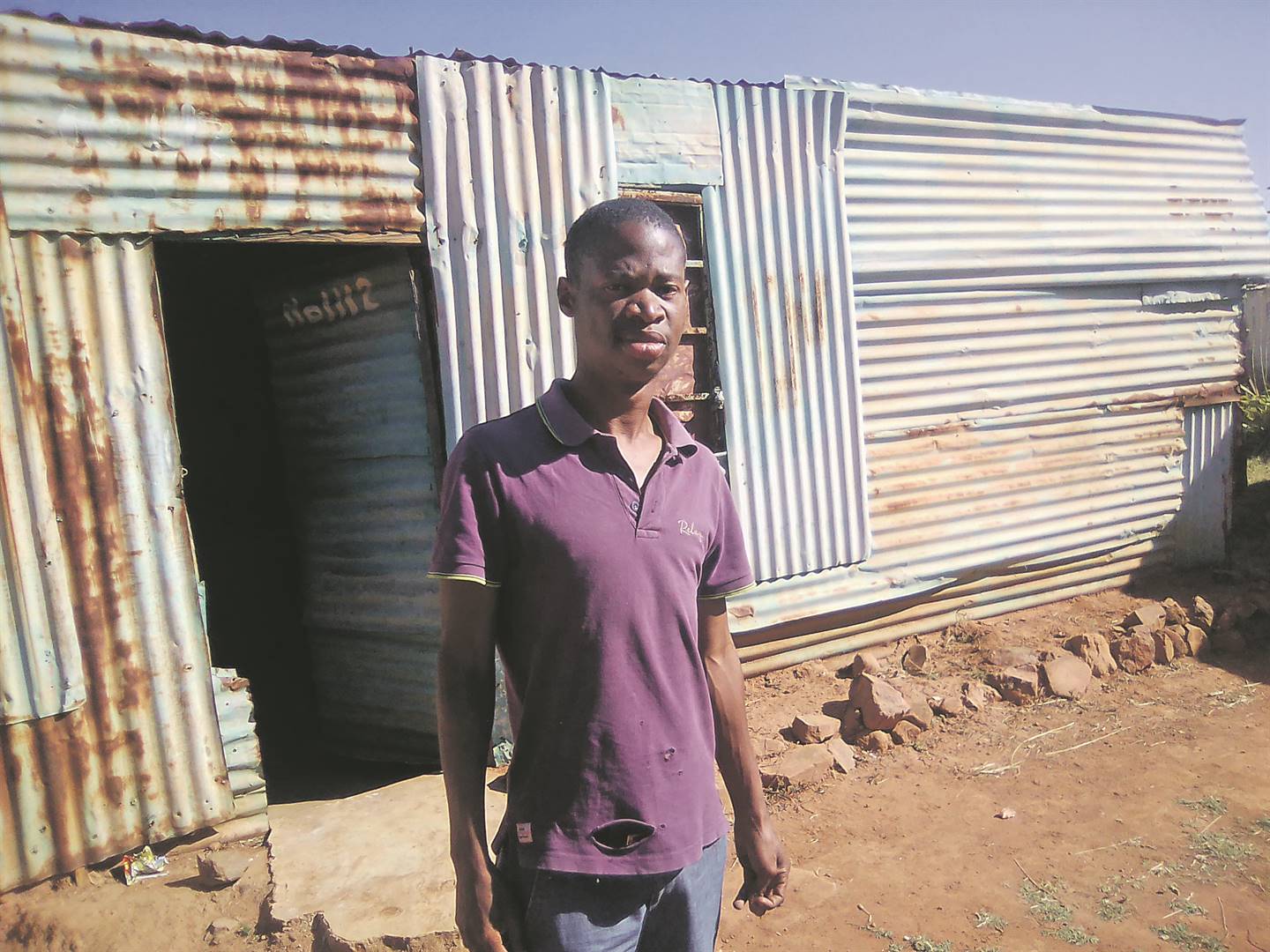 Gift Sikhosana in front of the dilapidated shack which he calls his home.    Photo by Bongani Mthimunye