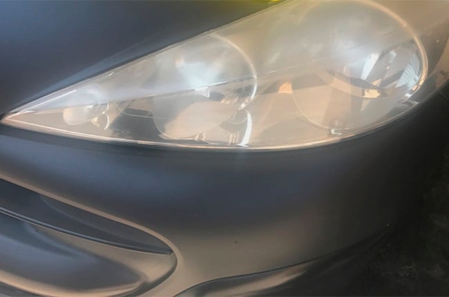 A typically fogged plastic headlight cover.
