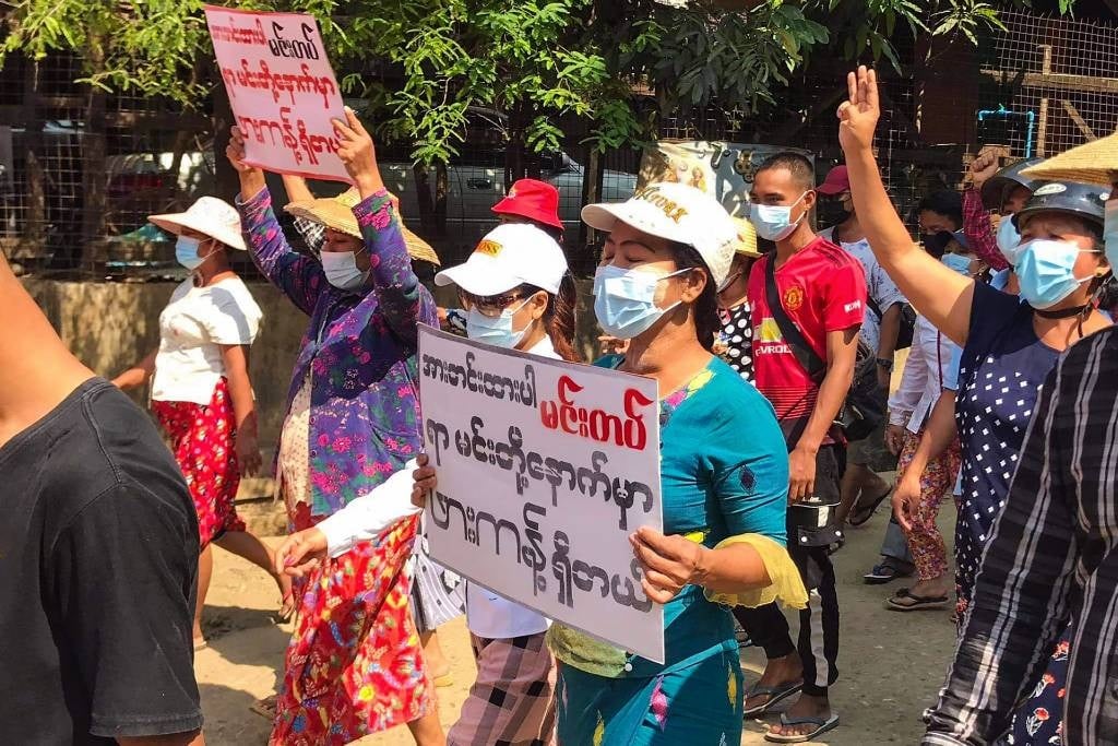 Myanmar protesters in Hpakant holding signs
