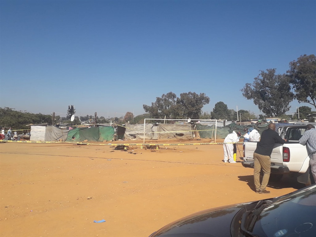 Four bodies lying in soccer filed after being killed by a mob in Zandspruit