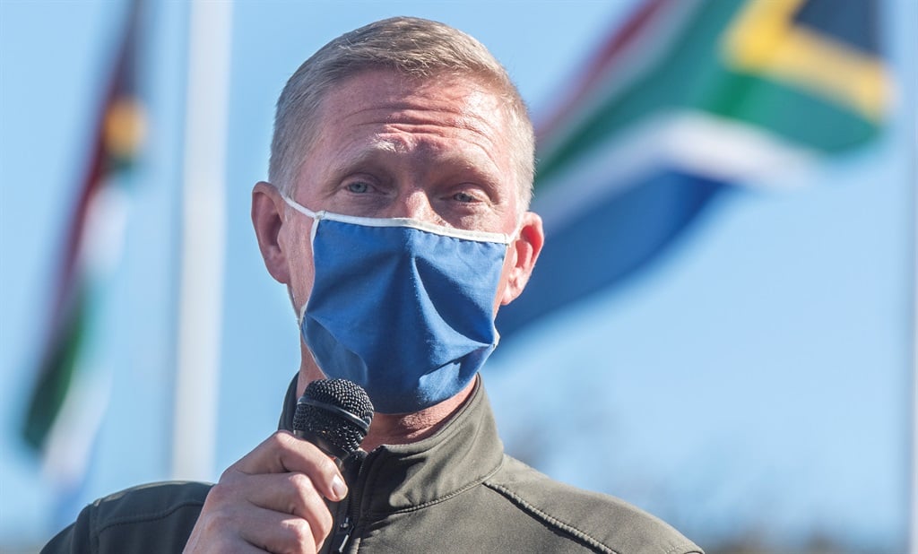 JP Smith seen giving speech outdoors, with SA flag in background