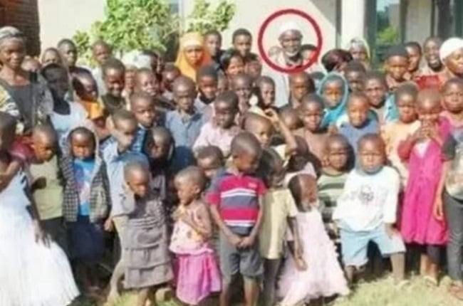 Mischek Nyandoro (circled in red) stands with some of his wives and kids. (Photo: COLLECT)