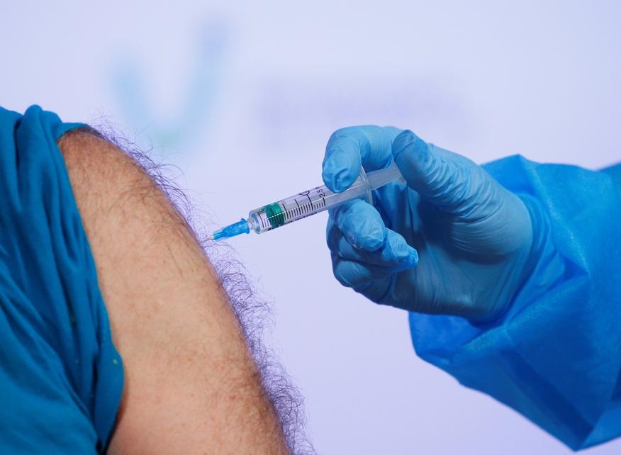 A person receives a dose of the Oxford University/AstraZeneca vaccine against the coronavirus disease (COVID-19), which is produced in India and marketed as Covishield, at a hospital in Kyiv, Ukraine March 16, 2021. REUTERS/Gleb Garanich 