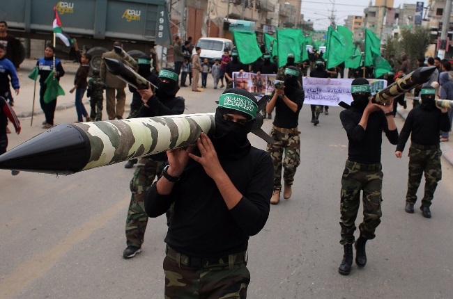 Hamas militants carry mock rockets during a protest march in Gaza. (PHOTO: Gallo Images/Getty Images)