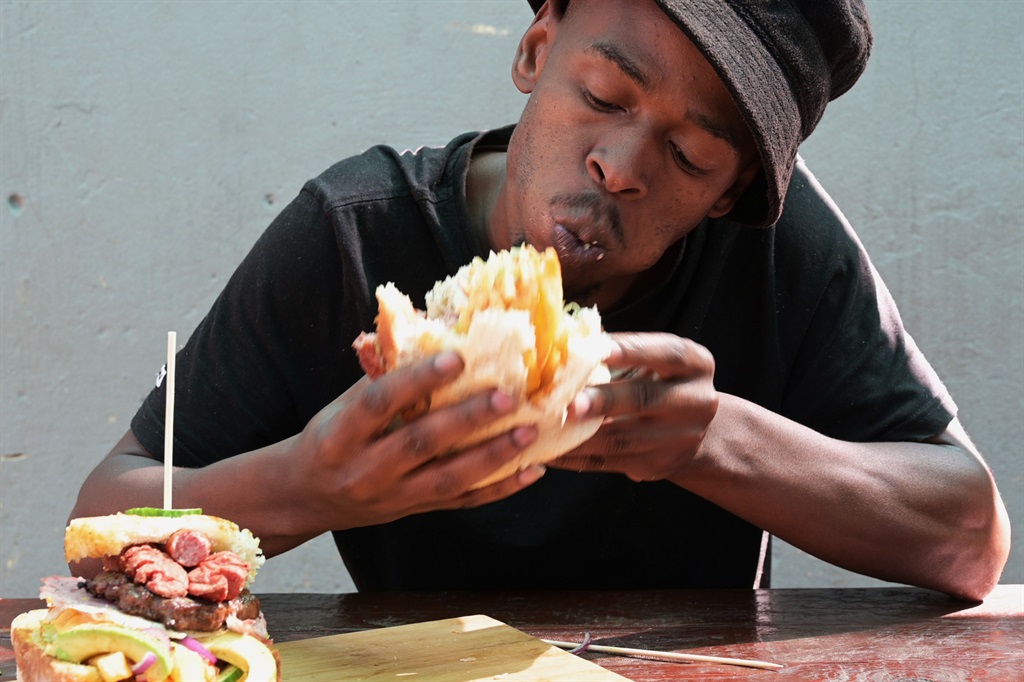 Tebogo Ndlovu (30) enjoying his kota meal. Photo b