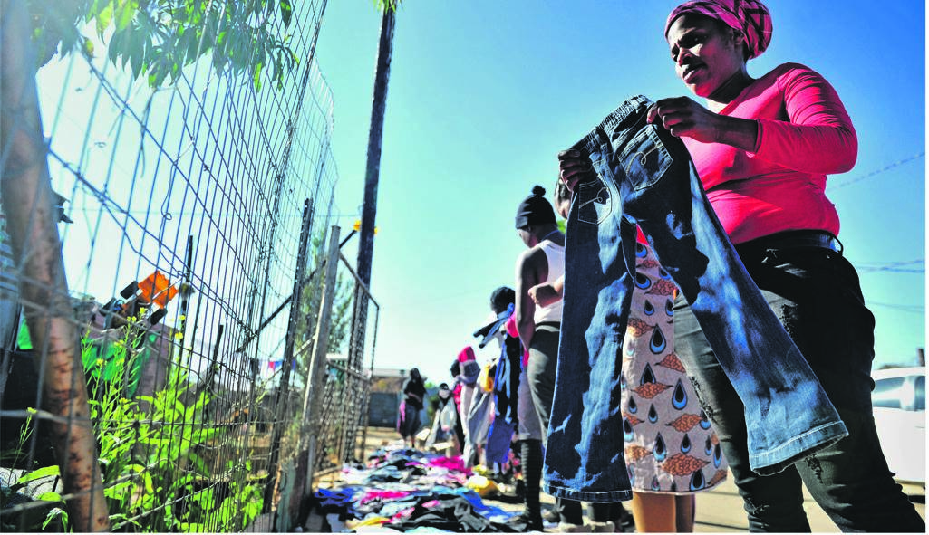 People living in Protea South, Soweto, pick out donated clothes during a  clothing drive   Photo: Rosetta Msimango