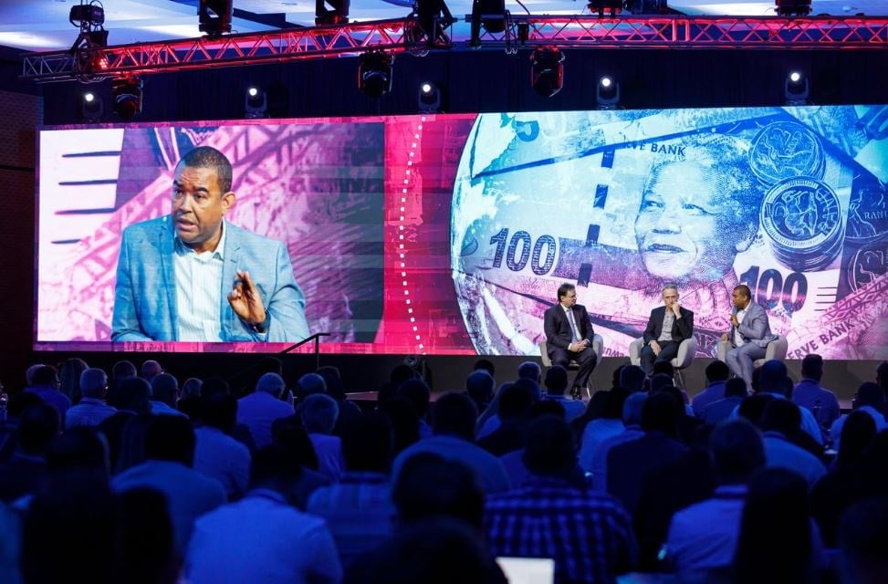 Rudy Dix (far right), Director of Project Management in the Office of the President, speaks at the Investment Summit in Cape Town. From left: Stanlib Chief Economist Kevin Rings and Traxtion Group CEO James Hawley.  (Provided/Investment Summit) 