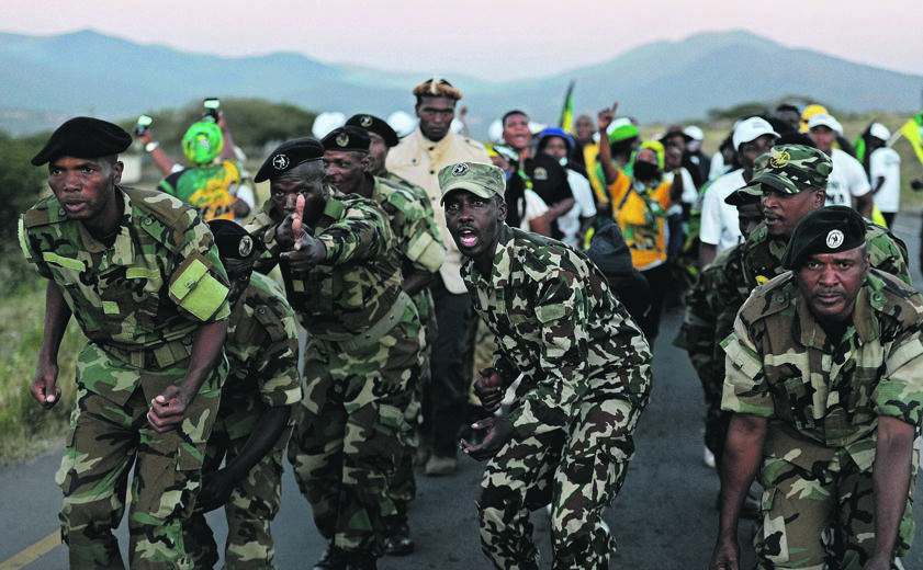 Former president Jacob Zuma’s supporters and members of the Umkhonto weSizwe Military Veterans’ Association march along the road near his home in Nkandla on Friday to protest the ruling that Zuma must go to jail for 15 months Photo: TEBOGO LETSIE