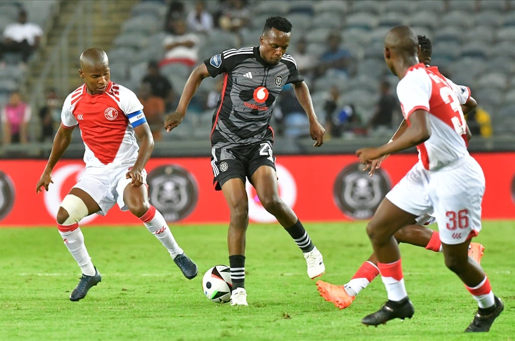 JOHANNESBURG, SOUTH AFRICA - MARCH 06:  Patrick Maswanganyi of Orlando Pirates with the ball challenged during the DStv Premiership match between Orlando Pirates and Cape Town Spurs at Orlando Stadium on March 06, 2024 in Johannesburg, South Africa. (Photo by Sydney Seshibedi/Gallo Images)
