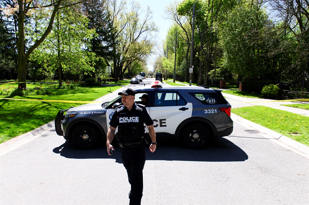 Toronto police patrol outside the home of Canadian rapper Drake after reports of a shooting early on May 7, 2024, according to media reports. (Christopher Katsarov Luna/AFP)