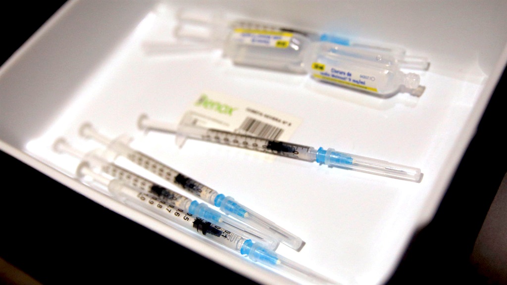 Syringes and vials with Pfizers vaccine against Co