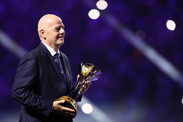 FIFA president Gianni Infantino holding the FIFA Club World Cup trophy.