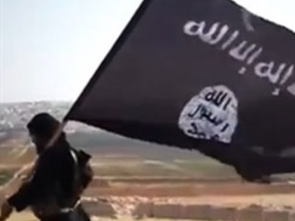 A member of Ussud Al-Anbar (Anbar Lions), a Jihadist group affiliated to the Islamic State of Iraq and the Levant , al-Qaeda's front group in Iraq, holding up the trademark black and white Islamist flag. (File, AFP)