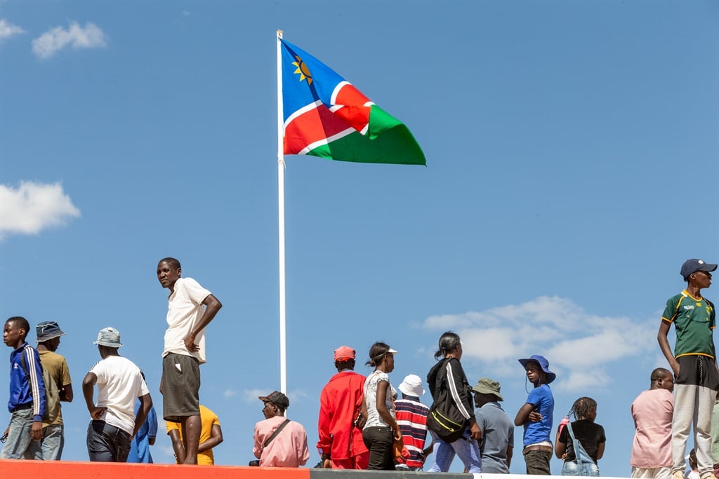 A Namibian flag stands among people who celebrate the 29th anniversary of liberation of Namibia, at the Independence Stadium, in Windhoek, Namibia, on March 21, 2019. (Photo by Christian Ender/Getty Images)