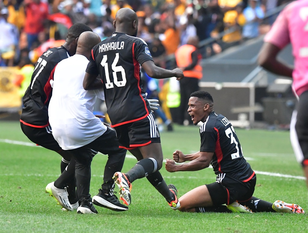 Thabiso Lebitso of Orlando Pirates is joined by his rushing team-mates to celebrate his thunderous goal during the Soweto derby DStv Premiership match against Kaizer Chiefs at FNB Stadium on 9 March 2024 in Johannesburg, South Africa. 