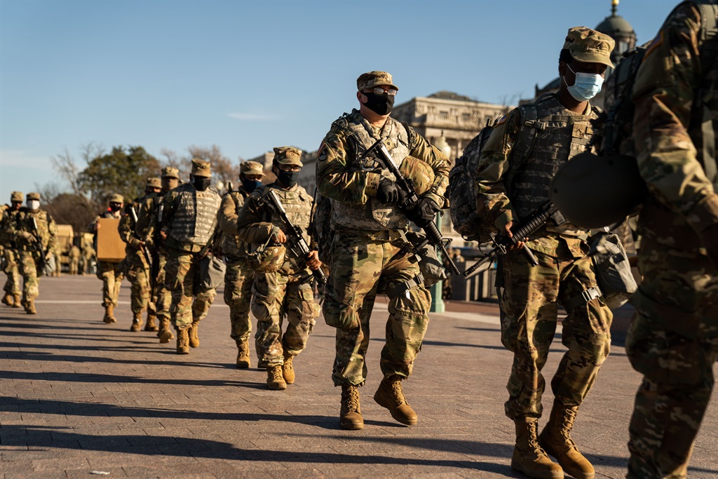 Members of the National Guard, outside the U.S. Capitol Building  a day after the House of Representatives impeached President Donald Trump. (Kent Nishimura / Los Angeles Times via Getty Images)