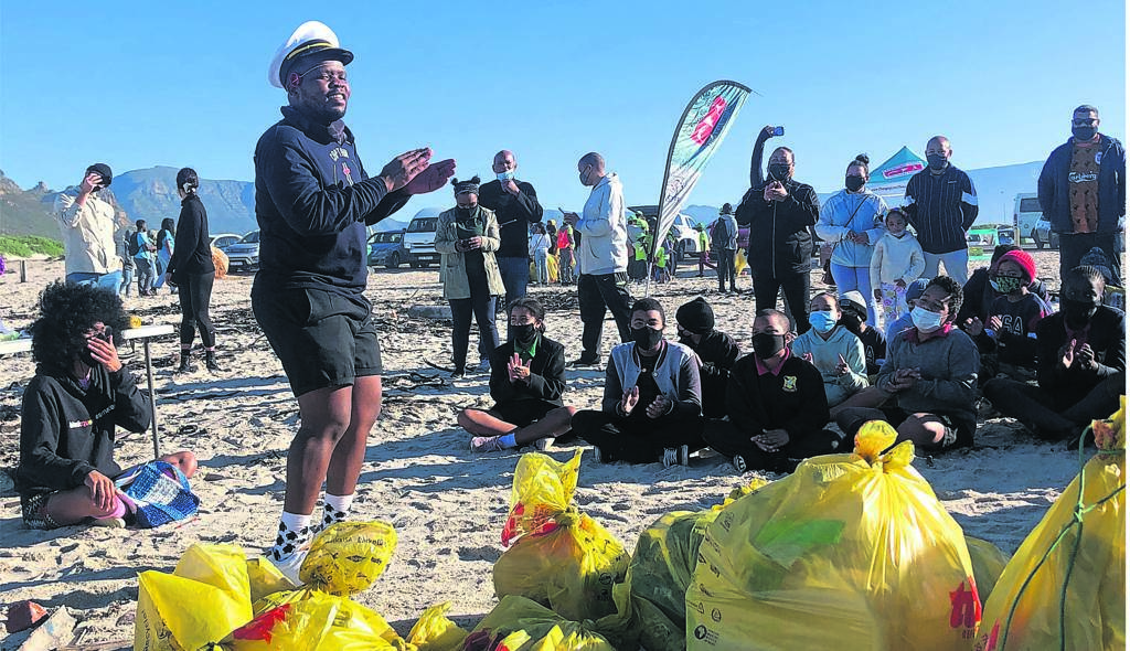 Captain Fanplastic gets the younger beach clean-up volunteers into gear. 