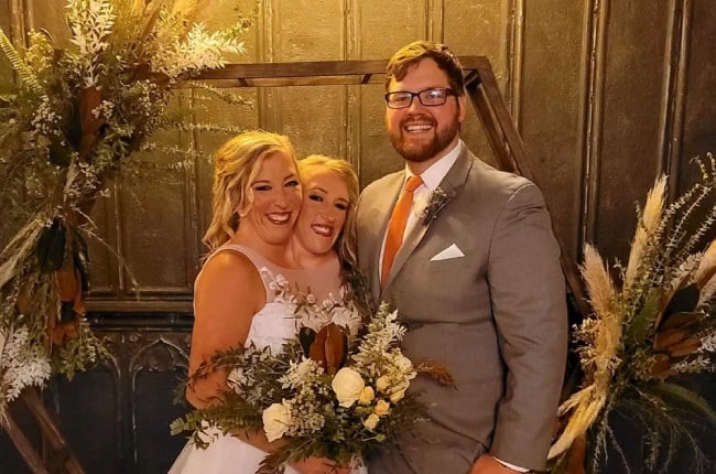 Conjoined twins Abby and Brittany Hensel with groom Josh Bowling on Abby's wedding day. (PHOTO: Facebook/Abby and Brittany Hensel)