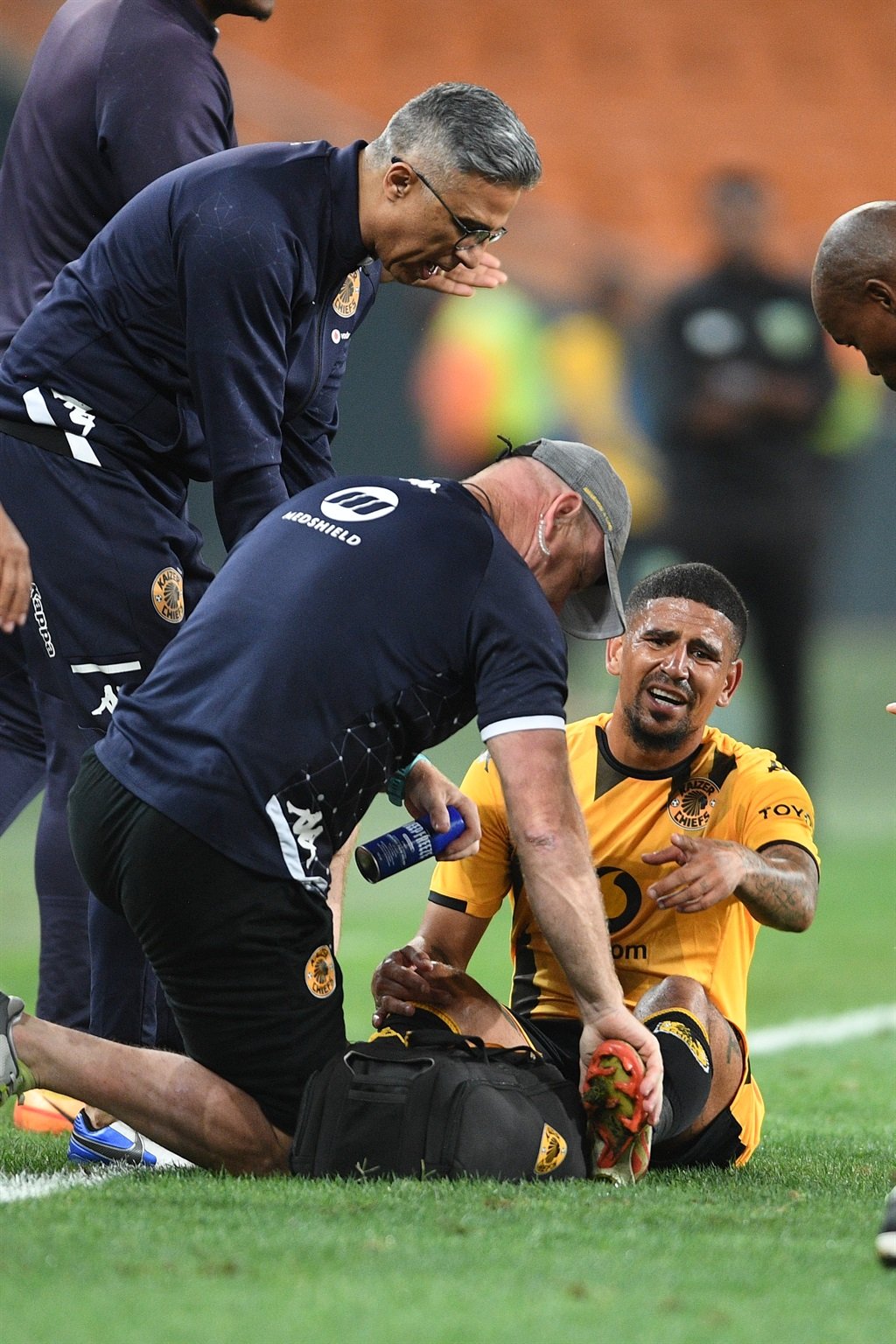 JOHANNESBURG, SOUTH AFRICA - MARCH 05:  Keagan Dolly of Kaizer Chiefs injured while Dr Mohammed Moosajee and David Milner during the DStv Premiership match between Kaizer Chiefs and Golden Arrows at FNB Stadium on March 05, 2024 in Johannesburg, South Africa. (Photo by Lefty Shivambu/Gallo Images)