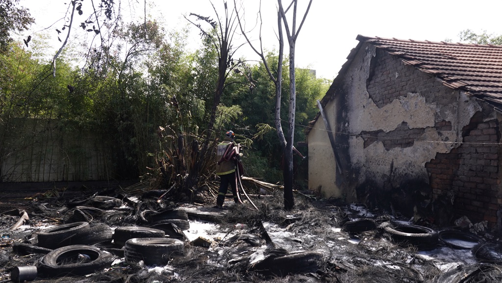 Fire Ops on the scene where a fire allegedly started by one of the tenants, who threw a cigarette at a stack of tyres in the back yard. (Alfonso Nqunjana/News24)
