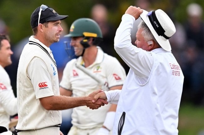 New Zealand captain Tim Southee, left, shakes hands with South African umpire Marais Erasmus, right, who stood in his last Test, the second Test between New Zealand and Australia, in Christchurch, which ended on Monday. (Kai Schwoerer/Getty Images)