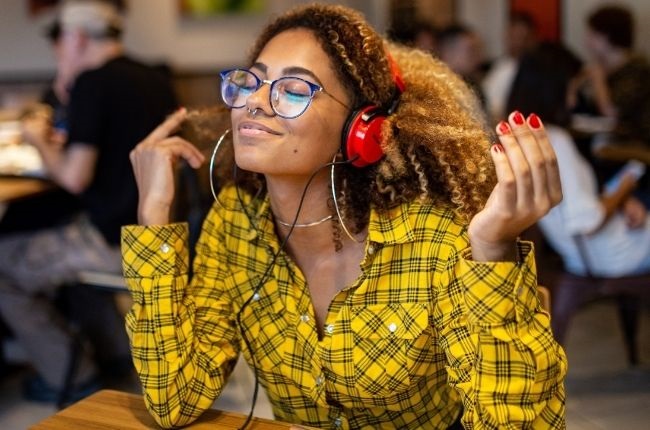 Woman listening to music with headphones. 
