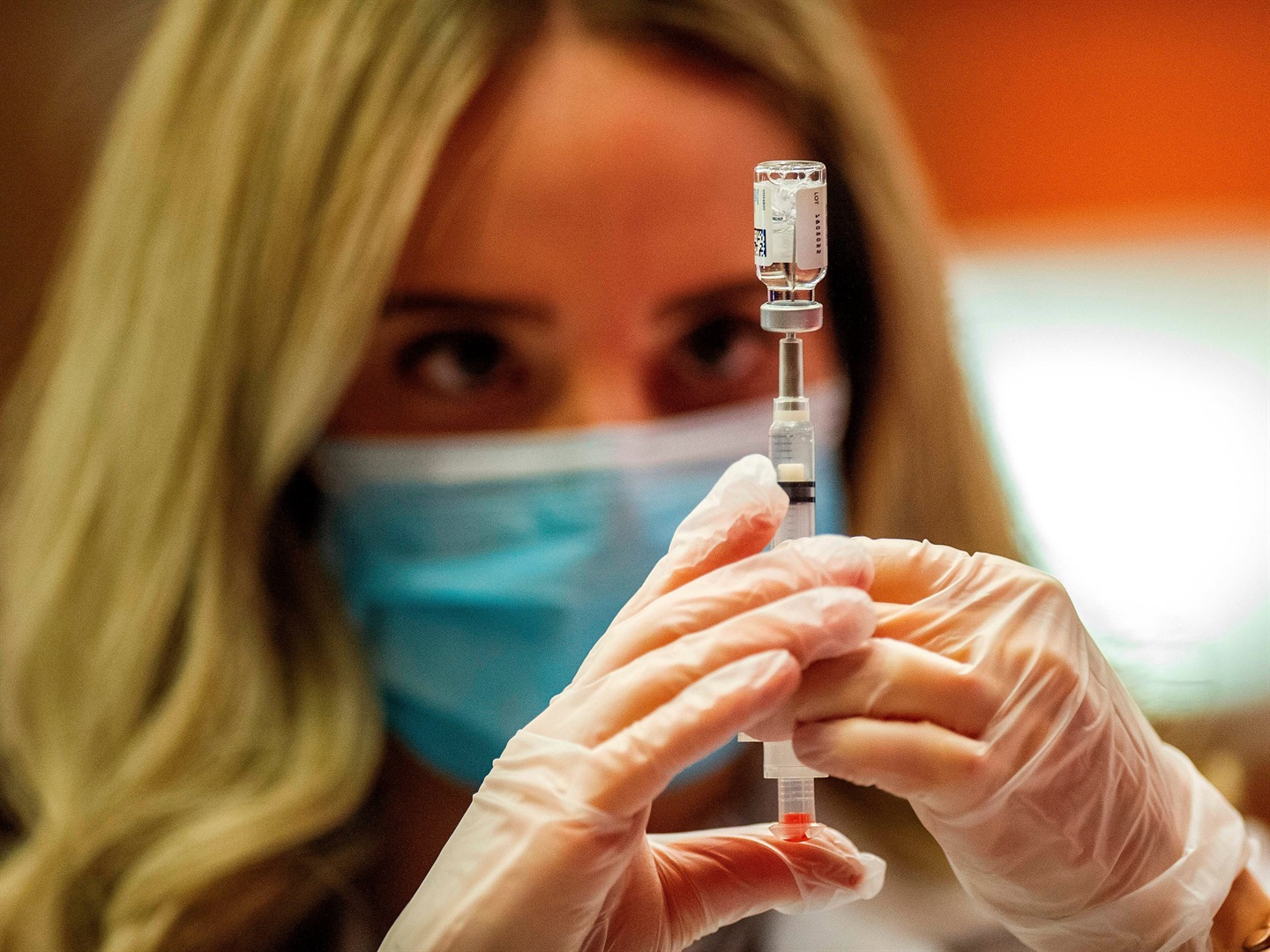 A pharmacist fills a syringe with the Johnson & Johnson Covid-19 vaccine.