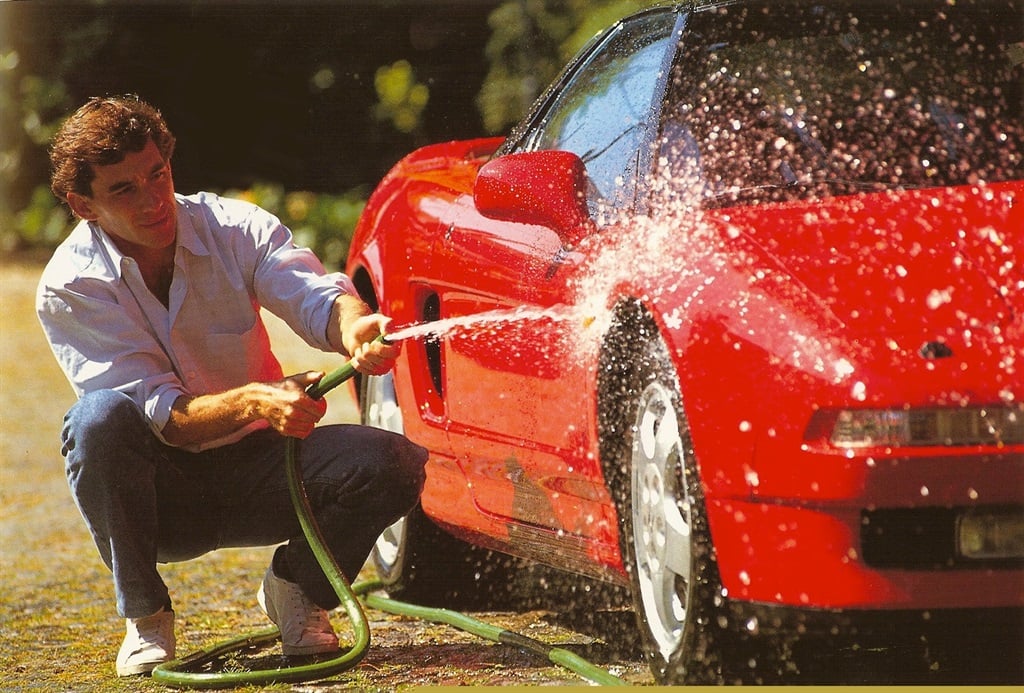The late Ayrton Senna pictured washing his red Honda NSX. [Image: Supplied by Autotrader, Norio Koike]