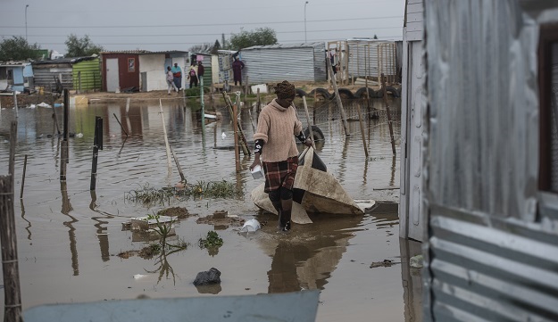 People fetching their belongings from their flooded homes at an Informal Settlement in Bloekombos , Kraaifontein.