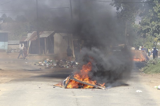 A barricade in the road that is on fire is seen in Mbabane, Eswatini, amid protests. 