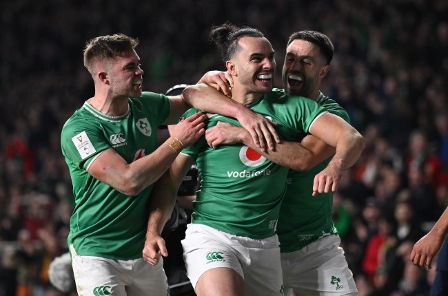Ireland winger James Lowe, centre, celebrates with teammates Jack Crowley and Conor Murray after scoring his second try in a losing cause against England at Twickenham on Saturday. (Mike Hewitt/Getty Images)