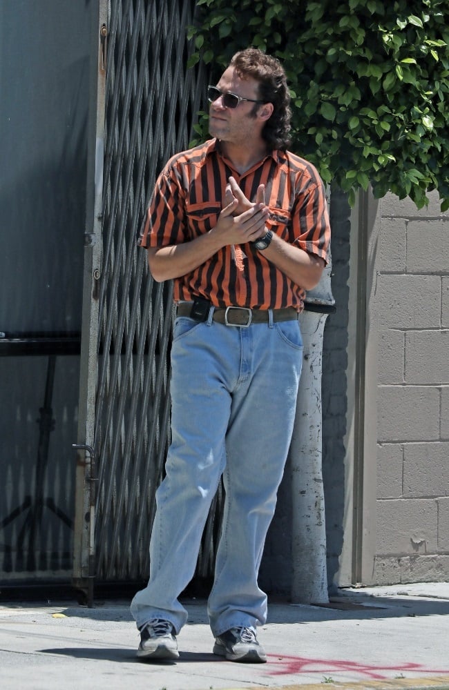 Seth Rogan rocked a mullet, striped shirt, jeans, 