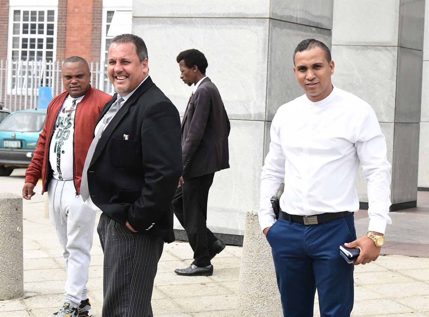 Warrant Officer Severiano Blundin (right) leaves the Gqeberha Magistrate's Court with his lawyer, advocate Jason Thysse. (Lulama Zenzile/Netwerk24)