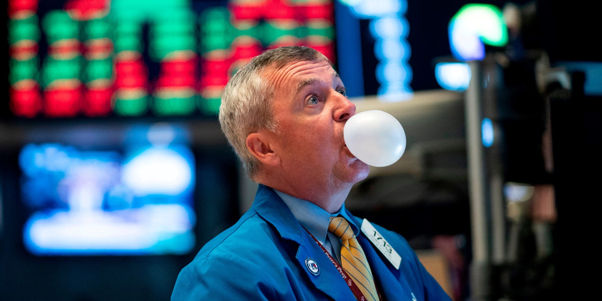 A trader blows bubble gum during the opening bell at the New York Stock Exchange (NYSE) on August 1, 2019, in New York City. Johannes Eisele/AFP via Getty Images