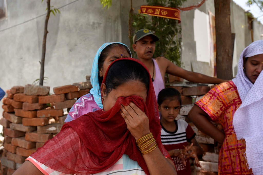 FARIDABAD, INDIA - JULY 8: Residents break down du