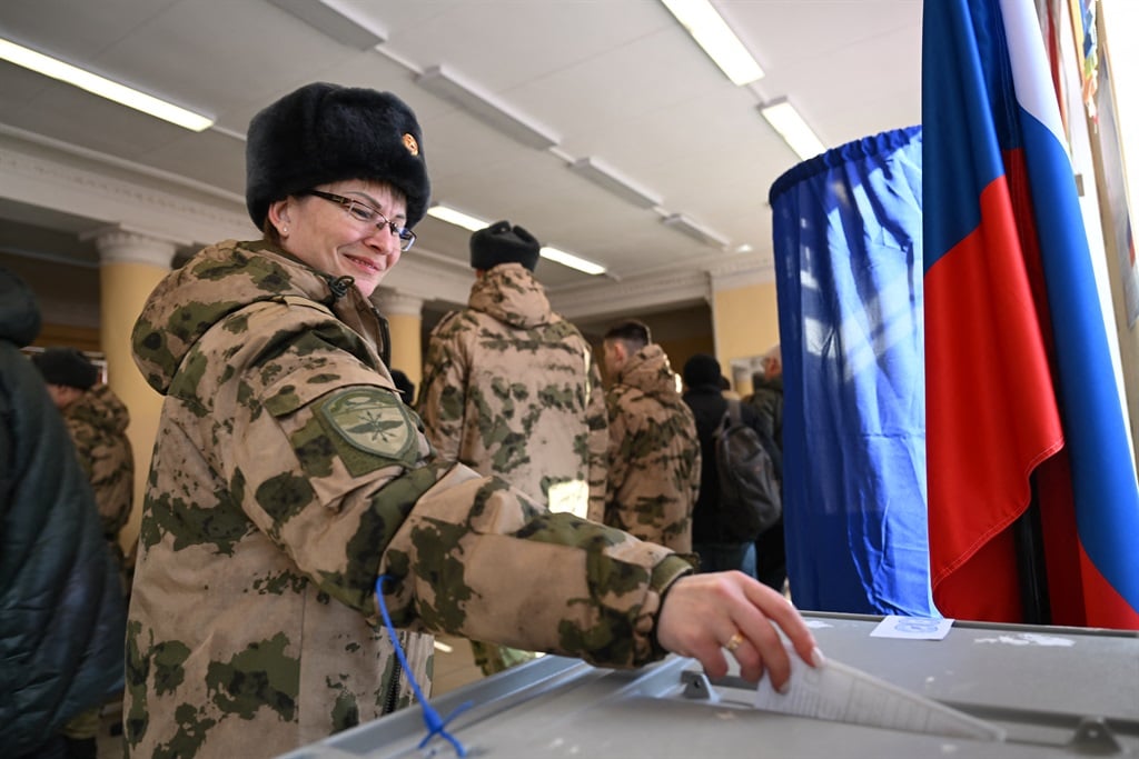 A service member casts her ballot in Russia's presidential election in Moscow on 15 March 2024. (Natalia Kolesnikova/ AFP)